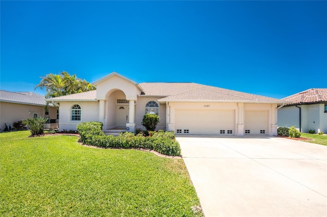 1157 Rotonda Cir, Rotonda West, FL 33947 - view of front of property with an attached garage, driveway, a front lawn, and stucco siding