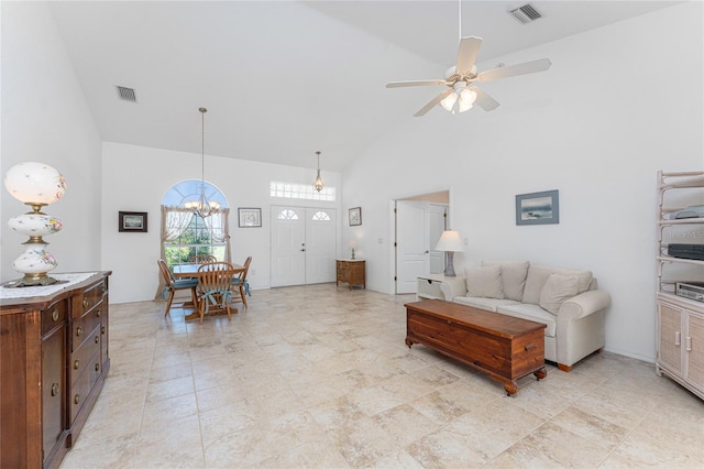 1157 Rotonda Cir, Rotonda West, FL 33947 - living room featuring high vaulted ceiling, a ceiling fan, and a chandelier