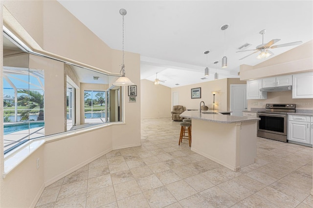 1157 Rotonda Cir, Rotonda West, FL 33947 - kitchen with stainless steel electric range oven, ceiling fan, open floor plan, under cabinet range hood, and plenty of natural light