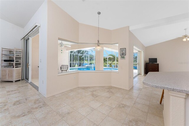 1157 Rotonda Cir, Rotonda West, FL 33947 - unfurnished dining area with vaulted ceiling, a ceiling fan, and baseboards