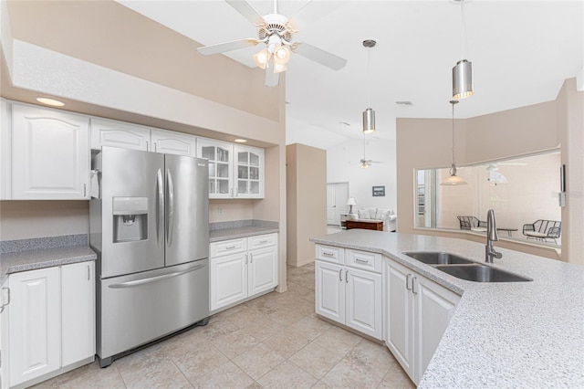 1157 Rotonda Cir, Rotonda West, FL 33947 - kitchen with stainless steel fridge, a sink, ceiling fan, white cabinets, and lofted ceiling