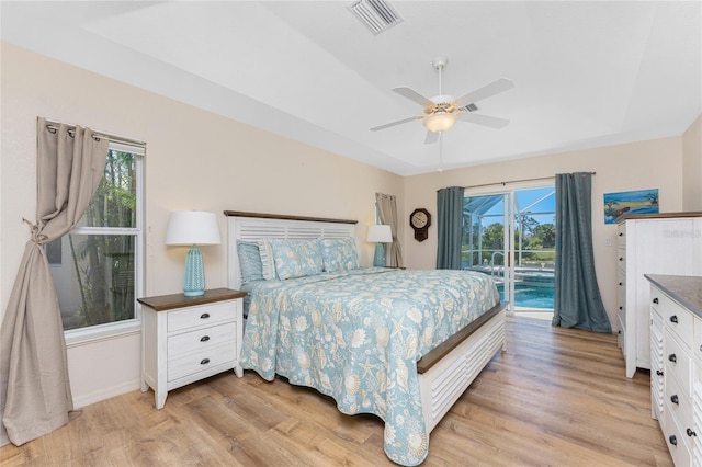 1157 Rotonda Cir, Rotonda West, FL 33947 - bedroom with access to exterior, light wood finished floors, a ceiling fan, and baseboards