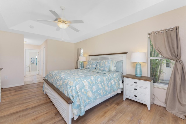 1157 Rotonda Cir, Rotonda West, FL 33947 - bedroom featuring light wood finished floors, a ceiling fan, and a tray ceiling