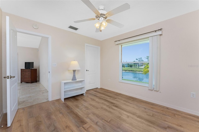 1157 Rotonda Cir, Rotonda West, FL 33947 - unfurnished bedroom featuring light wood-style flooring, baseboards, and a ceiling fan