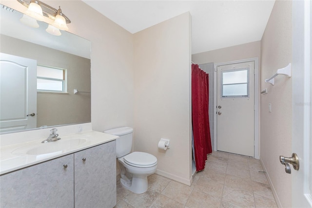 1157 Rotonda Cir, Rotonda West, FL 33947 - bathroom with toilet, vanity, tile patterned floors, baseboards, and a shower with curtain