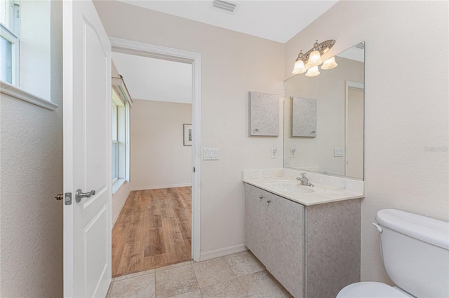 1157 Rotonda Cir, Rotonda West, FL 33947 - bathroom featuring toilet, plenty of natural light, vanity, and baseboards
