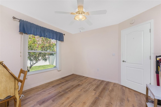 1157 Rotonda Cir, Rotonda West, FL 33947 - empty room with light wood finished floors, a ceiling fan, baseboards, and a smoke detector