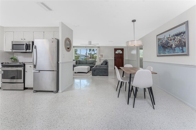 1691 Lakeview Pl, Englewood, FL 34223 - dining area with a ceiling fan, dark speckled floor, and baseboards