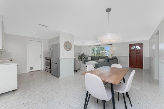 1691 Lakeview Pl, Englewood, FL 34223 - dining space with a ceiling fan and dark speckled floor
