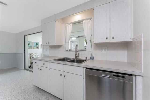 1691 Lakeview Pl, Englewood, FL 34223 - kitchen featuring dishwasher, a sink, tasteful backsplash, and white cabinets
