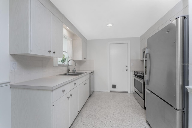 1691 Lakeview Pl, Englewood, FL 34223 - kitchen featuring stainless steel appliances, a sink, light countertops, backsplash, and dark speckled floor