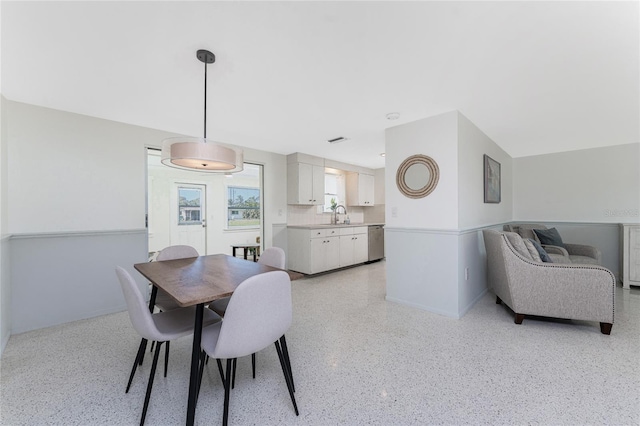 1691 Lakeview Pl, Englewood, FL 34223 - dining area featuring dark aggregate flooring and baseboards