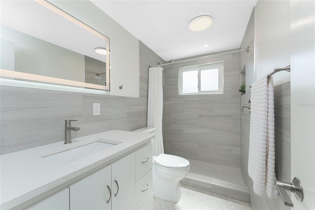 1691 Lakeview Pl, Englewood, FL 34223 - bathroom with speckled floor, a tile shower, tile walls, toilet, and vanity
