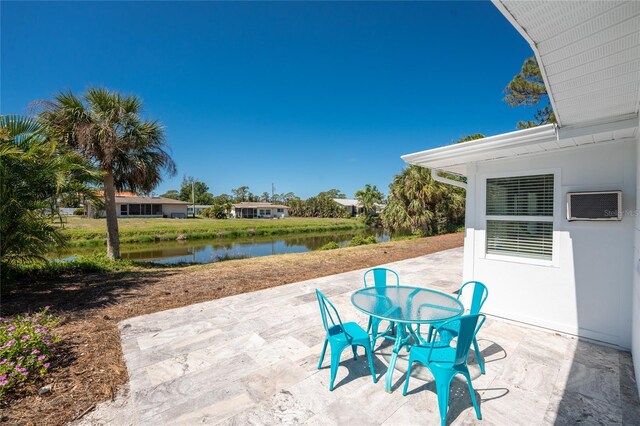 1691 Lakeview Pl, Englewood, FL 34223 - view of patio / terrace with a water view, a wall mounted air conditioner, and outdoor dining area