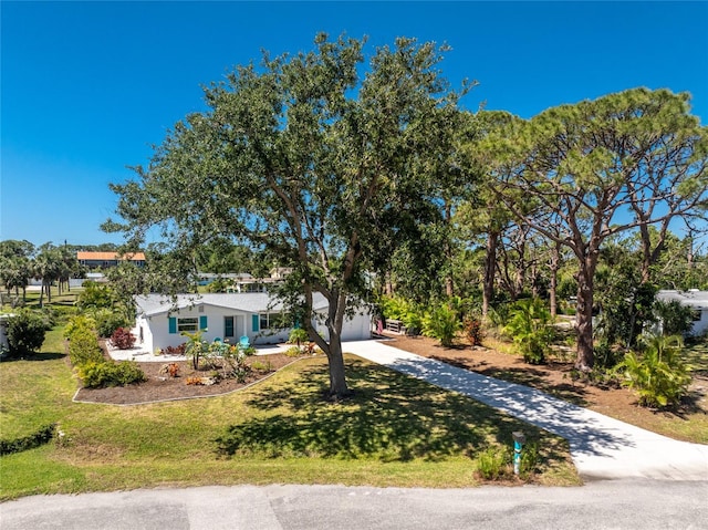 1691 Lakeview Pl, Englewood, FL 34223 - view of front facade with concrete driveway, a front yard, and a garage