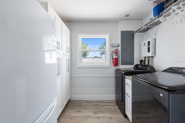 2060 Oyster Creek Dr, Englewood, FL 34224 - laundry area featuring cabinet space, washer and dryer, light wood-style flooring, electric panel, and baseboards