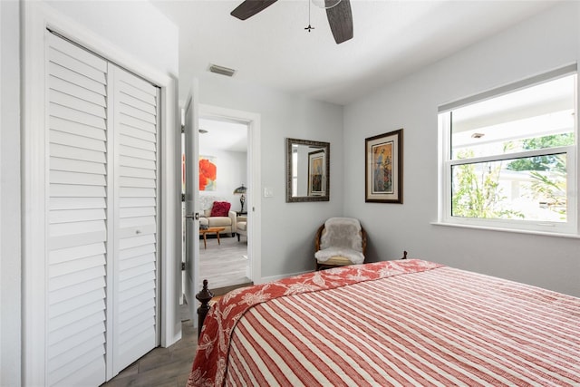 2060 Oyster Creek Dr, Englewood, FL 34224 - bedroom with dark wood-type flooring, a ceiling fan, a closet, and baseboards