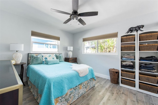 2060 Oyster Creek Dr, Englewood, FL 34224 - bedroom with multiple windows, wood finished floors, and baseboards