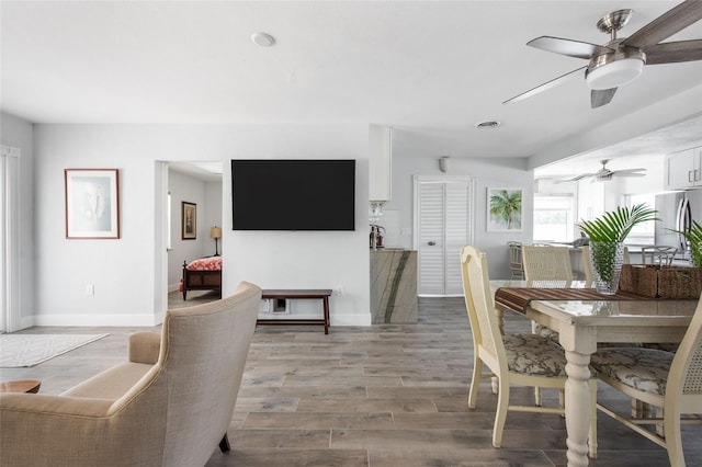 2060 Oyster Creek Dr, Englewood, FL 34224 - dining area with a ceiling fan, baseboards, and light wood-style floors