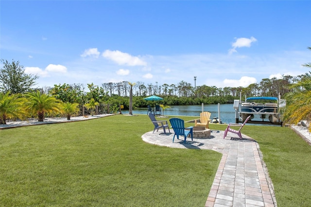 2060 Oyster Creek Dr, Englewood, FL 34224 - view of green lawn with an outdoor fire pit, a water view, and a patio area