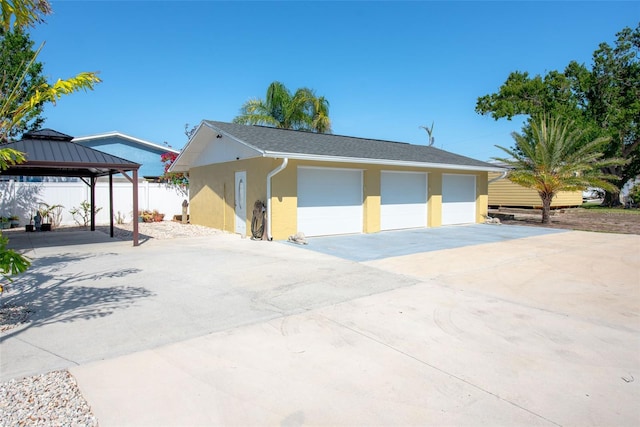 2060 Oyster Creek Dr, Englewood, FL 34224 - view of front of home with stucco siding, a garage, a gazebo, and an outbuilding
