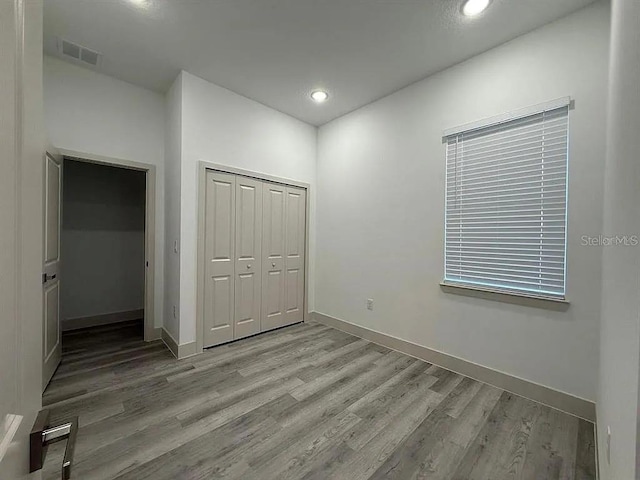 18043 Hillsborough Blvd, Port Charlotte, FL 33954 - unfurnished bedroom featuring wood finished floors, baseboards, and recessed lighting