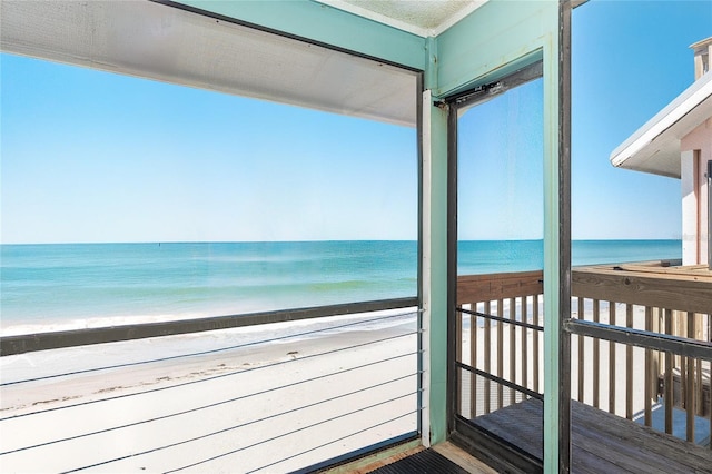 balcony with view of water and beach