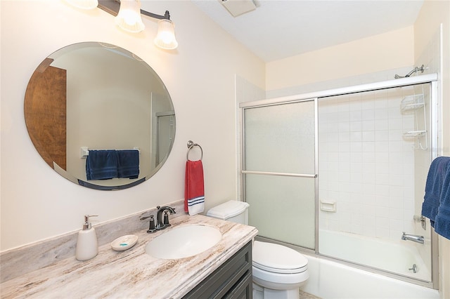 bathroom with toilet, vanity, and enclosed tub / shower combo
