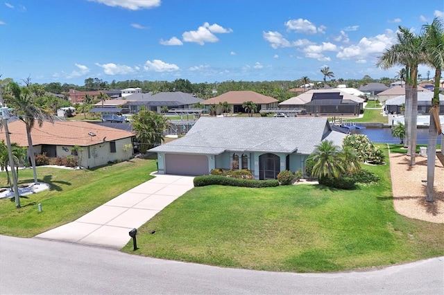 single story home with a residential view, concrete driveway, an attached garage, and a front yard