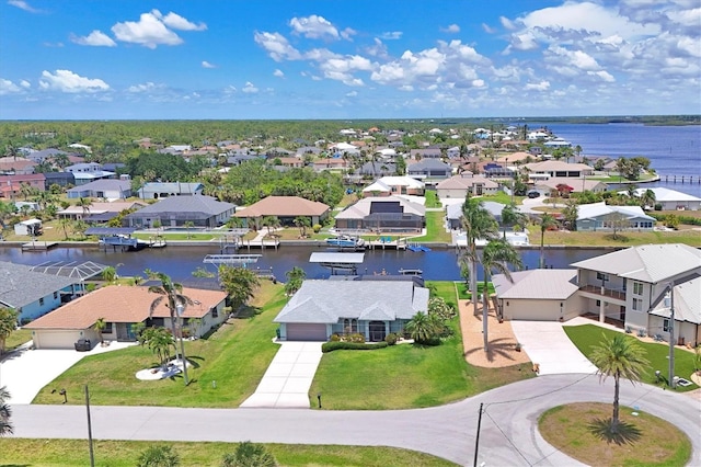 aerial view of residential area featuring a nearby body of water