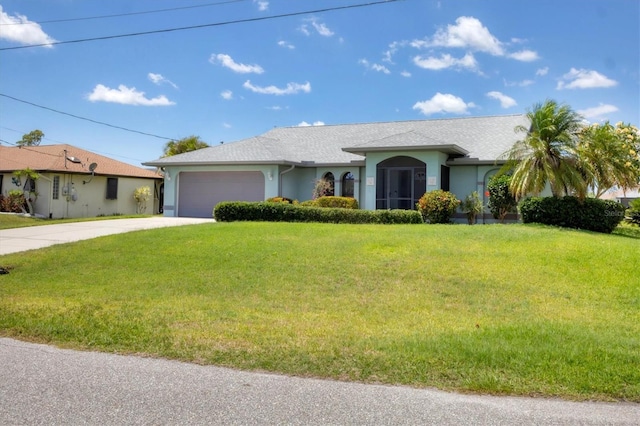 ranch-style home featuring driveway, stucco siding, a garage, and a front yard