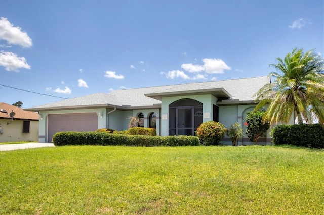 ranch-style house with stucco siding, a front yard, and a garage