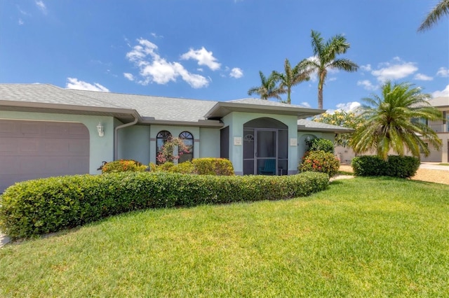 single story home featuring stucco siding, an attached garage, and a front yard