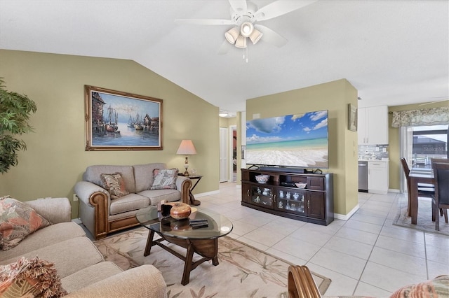living room with light tile patterned floors, lofted ceiling, ceiling fan, and baseboards