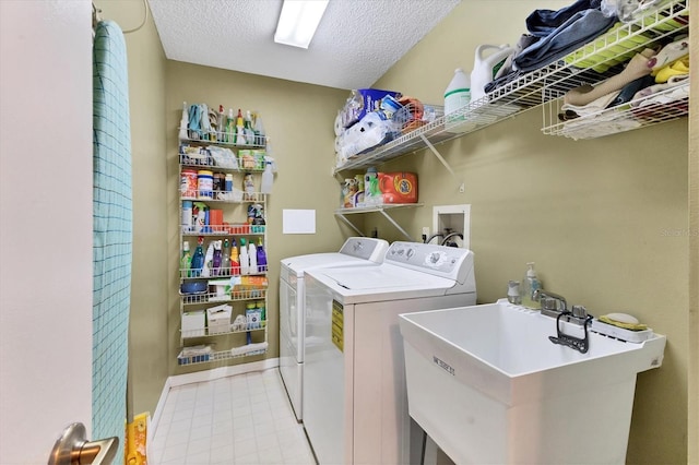 laundry area featuring washer and clothes dryer and a textured ceiling
