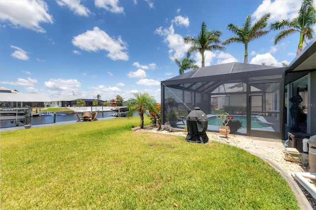 view of green lawn with an outdoor pool, a lanai, a dock, and a water view