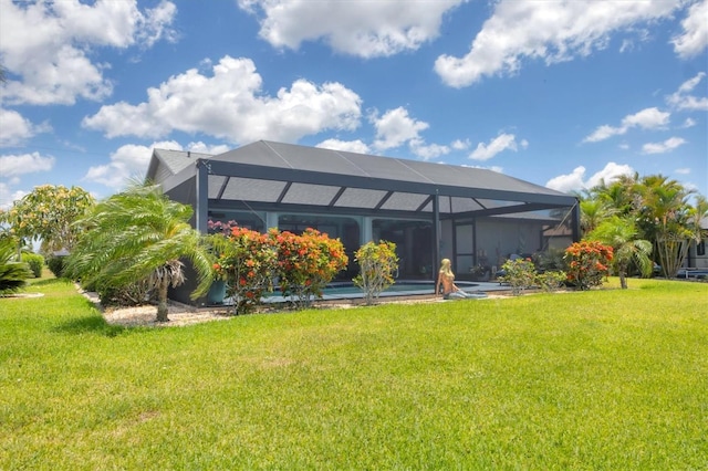 rear view of house featuring a yard and a lanai