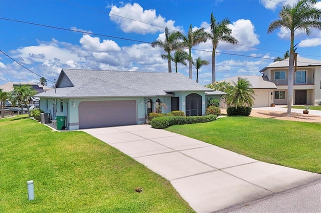 single story home with an attached garage, a front yard, driveway, and stucco siding