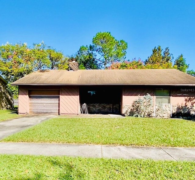 7639 Panthera Ct, Orlando, FL 32822 - view of front of property featuring concrete driveway, a garage, a front lawn, and a chimney