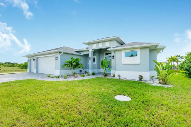 13344 Gershwin Ln, Port Charlotte, FL 33981 - prairie-style house with a garage, stucco siding, a front lawn, and driveway