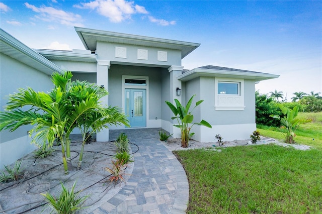 13344 Gershwin Ln, Port Charlotte, FL 33981 - property entrance featuring stucco siding and a lawn