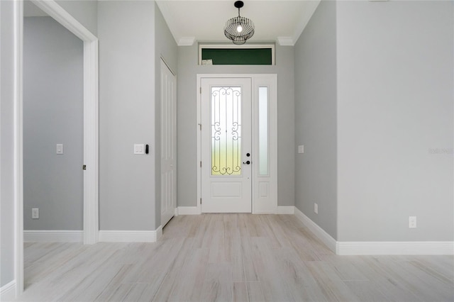 13344 Gershwin Ln, Port Charlotte, FL 33981 - foyer entrance with wood finished floors, baseboards, and crown molding