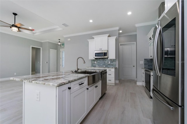 13344 Gershwin Ln, Port Charlotte, FL 33981 - kitchen with stainless steel appliances, a sink, a ceiling fan, decorative backsplash, and white cabinetry