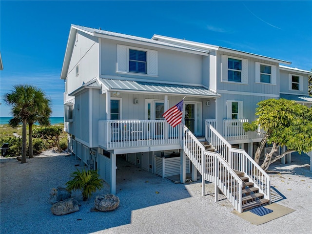 420 Gulf Blvd Unit 4, Boca Grande, FL 33921 - coastal home featuring metal roof, a porch, stairway, and a carport