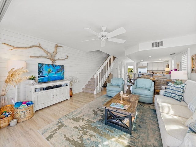 420 Gulf Blvd Unit 4, Boca Grande, FL 33921 - living room featuring light wood finished floors, a ceiling fan, and stairs