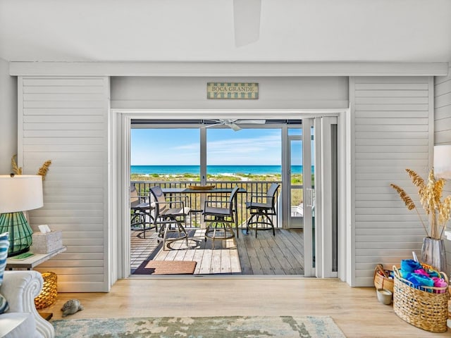 420 Gulf Blvd Unit 4, Boca Grande, FL 33921 - doorway with view of water and beach, wood finished floors, and plenty of natural light