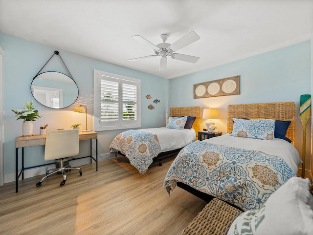 420 Gulf Blvd Unit 4, Boca Grande, FL 33921 - bedroom with wood finished floors, a desk, ceiling fan, and baseboards