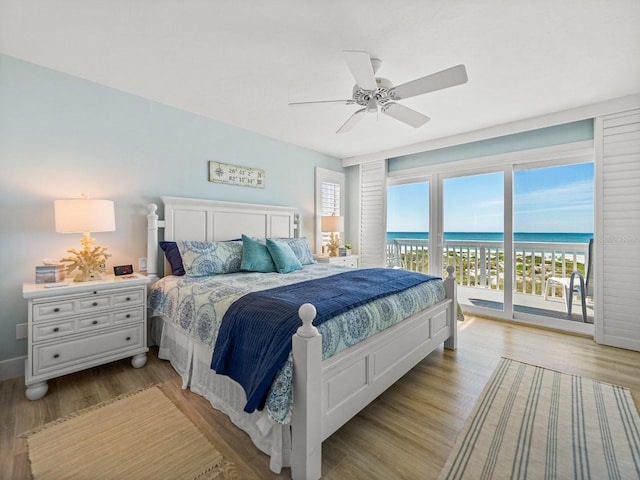 420 Gulf Blvd Unit 4, Boca Grande, FL 33921 - bedroom featuring access to exterior, light wood-style floors, a water view, and a ceiling fan