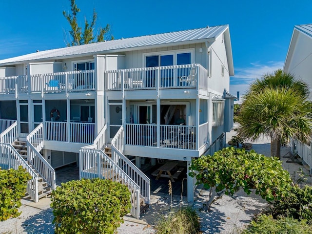 420 Gulf Blvd Unit 4, Boca Grande, FL 33921 - view of front facade with stairway, a balcony, metal roof, and a standing seam roof