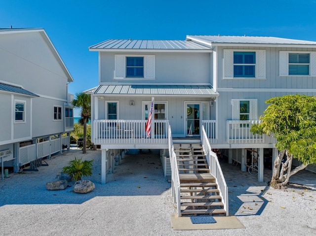 420 Gulf Blvd Unit 4, Boca Grande, FL 33921 - beach home featuring a carport, a porch, stairway, metal roof, and driveway